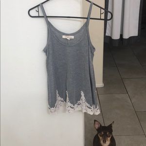 Grey tank top with white design.